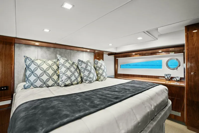 Gia Yacht Photos Pics Luxurious bedroom interior of 2021 Riviera 5400 Sport Yacht with elegant bedding and decor.