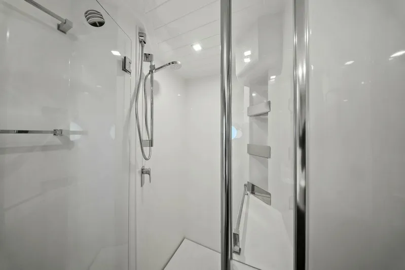 Gia Yacht Photos Pics Modern shower in 2021 Riviera 5400 Sport Yacht, featuring sleek chrome fixtures and white interior.