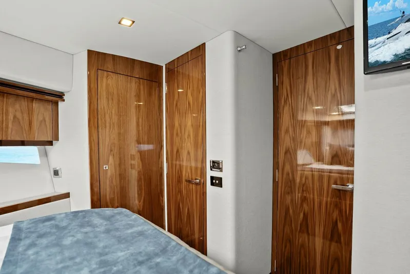 Gia Yacht Photos Pics Luxurious interior of 2021 Riviera 5400 Sport Yacht with wood paneling and modern design.