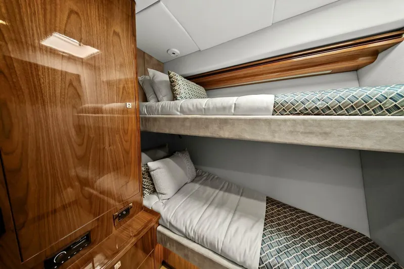 Gia Yacht Photos Pics 2021 Riviera 5400 Sport Yacht cabin with wooden finish and cozy bunk beds.