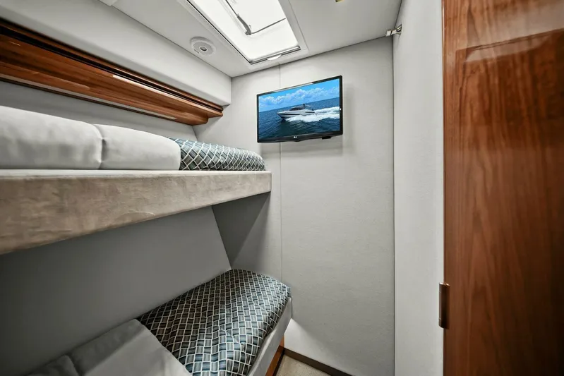 Gia Yacht Photos Pics Interior of 2021 Riviera 5400 Sport Yacht with bunk beds and wall-mounted TV.