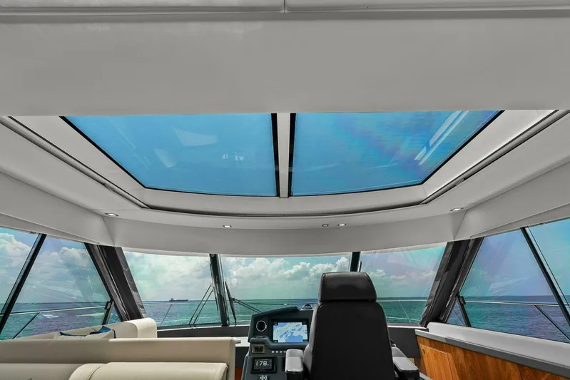 Gia Yacht Photos Pics Interior view of 2021 Riviera 5400 Sport Yacht with panoramic windows and modern helm.