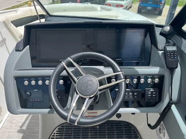  Yacht Photos Pics 2022 Cobalt 30SC boat dashboard with dual screens and steering wheel.