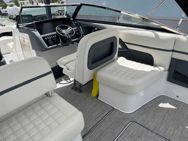  Yacht Photos Pics 2022 Cobalt 30SC boat interior with white seating and modern dashboard.