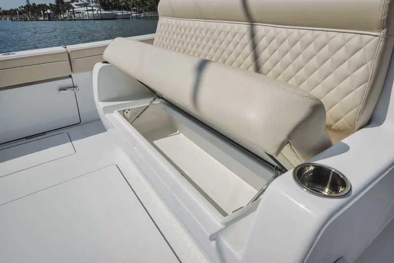 Primo Yacht Photos Pics 2023 Valhalla Boatworks V-41, beige cushioned seating with storage compartment.