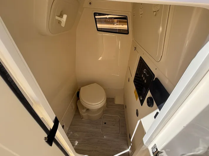  Yacht Photos Pics 2025 Scout 261 XSS boat interior bathroom with toilet and window.