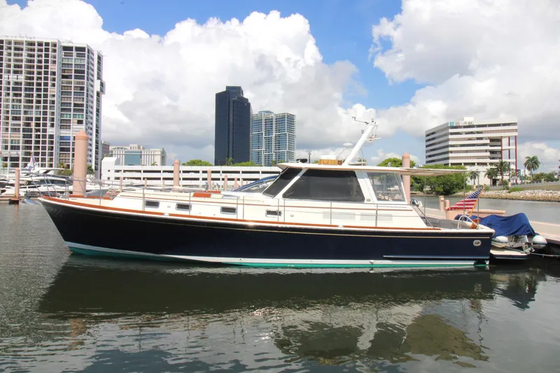 Sweet Yacht Photos Pics 2001 Grand Banks 49 Eastbay HX yacht docked in urban marina with city skyline.