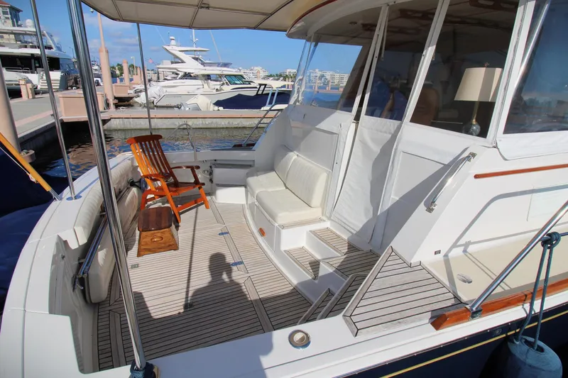 Sweet Yacht Photos Pics 2001 Grand Banks 49 Eastbay HX yacht deck with seating and wooden chair.