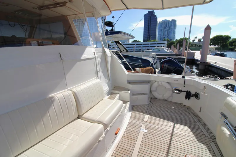 Sweet Yacht Photos Pics Luxurious 2001 Grand Banks 49 Eastbay HX yacht interior with white seating at marina.