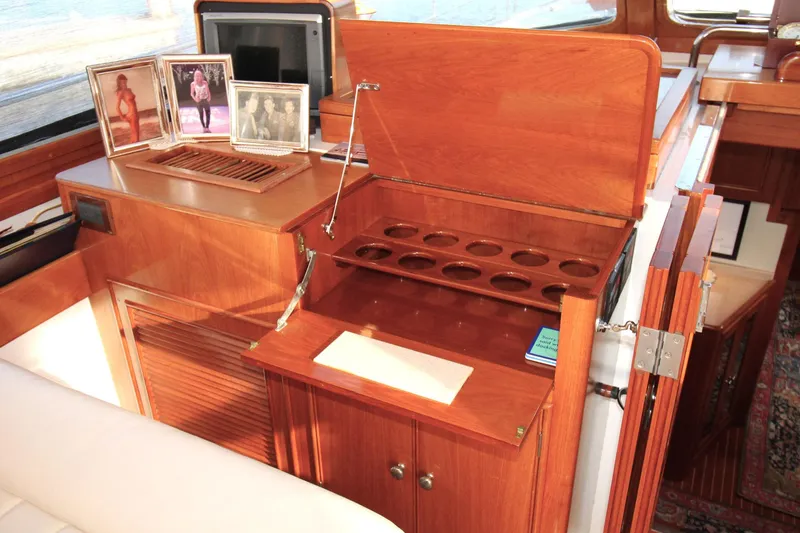 Sweet Yacht Photos Pics Interior of 2001 Grand Banks 49 Eastbay HX with wooden cabinetry and photo frames.