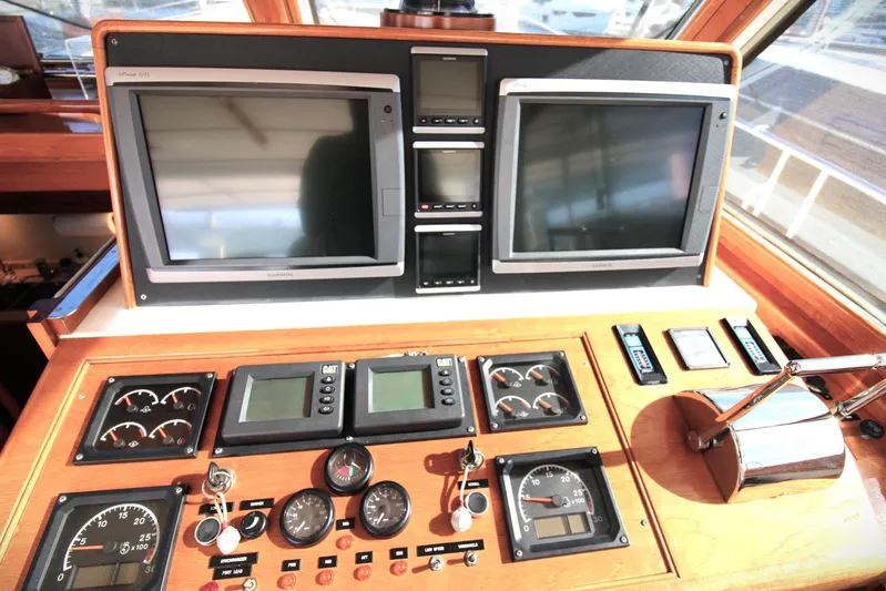 Sweet Yacht Photos Pics Control panel of 2001 Grand Banks 49 Eastbay HX yacht with navigation screens and gauges.