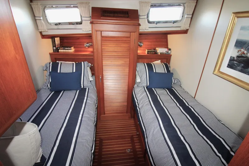 Sweet Yacht Photos Pics Cabin interior of 2001 Grand Banks 49 Eastbay HX with twin beds and nautical decor.