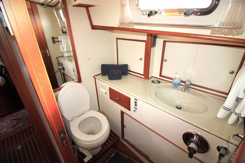 Sweet Yacht Photos Pics Bathroom interior of 2001 Grand Banks 49 Eastbay HX yacht, featuring sink and toilet.