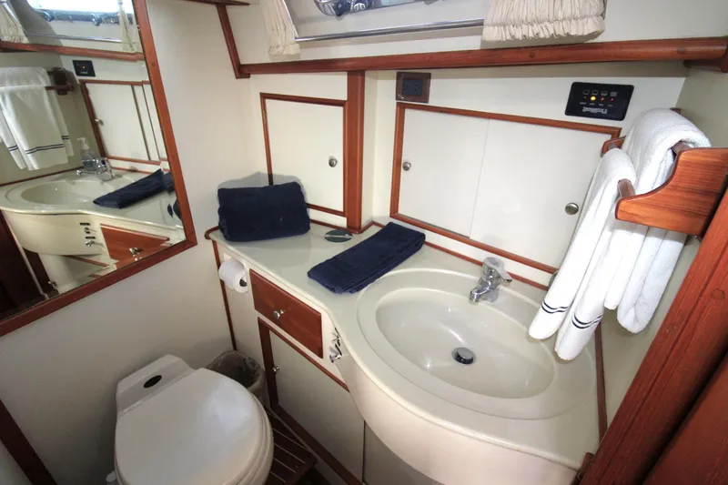 Sweet Yacht Photos Pics Luxurious bathroom in 2001 Grand Banks 49 Eastbay HX yacht, featuring sink and toilet.