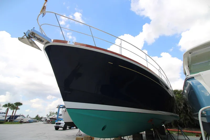 Sweet Yacht Photos Pics 2001 Grand Banks 49 Eastbay HX yacht on dry dock, showcasing sleek hull design.