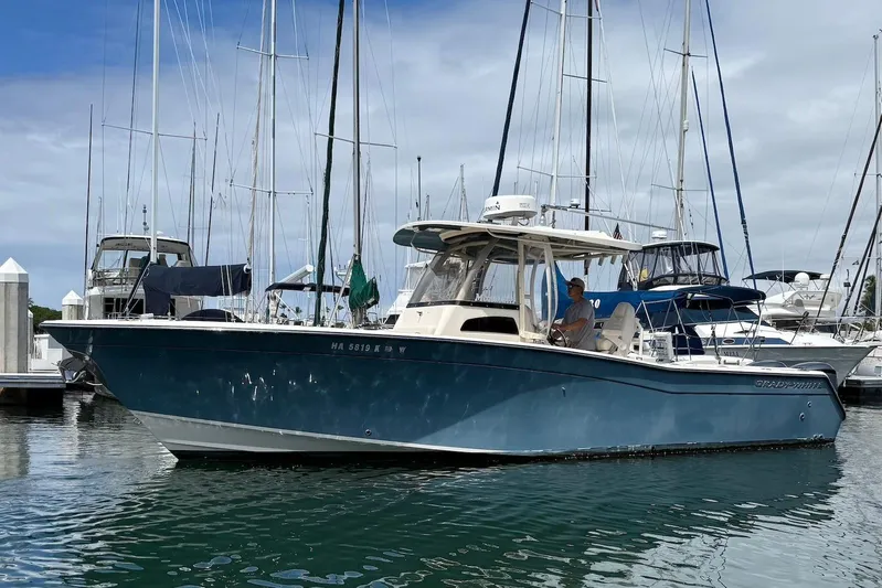  Yacht Photos Pics 2020 Grady-White Canyon 306 boat docked at marina, calm water, overcast sky.