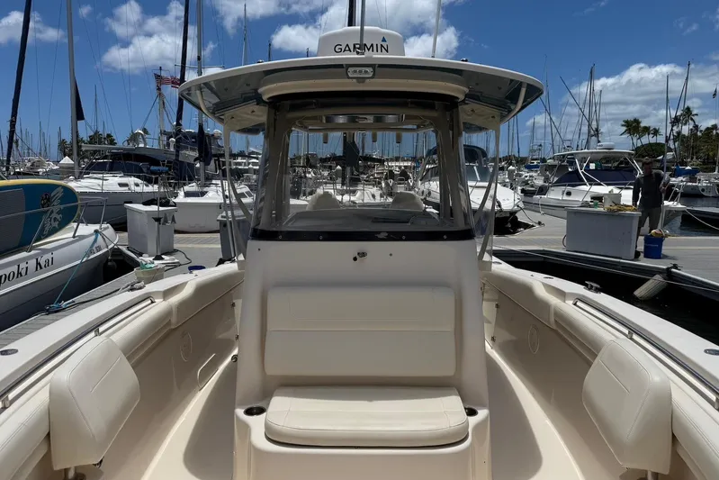  Yacht Photos Pics 2020 Grady-White Canyon 306 boat docked at a marina under a clear blue sky.