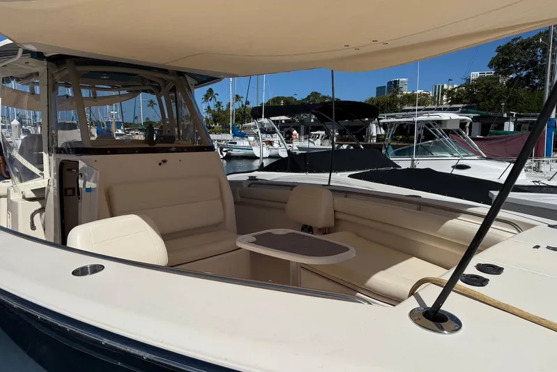  Yacht Photos Pics 2020 Grady-White Canyon 306 boat with seating area, docked at marina.