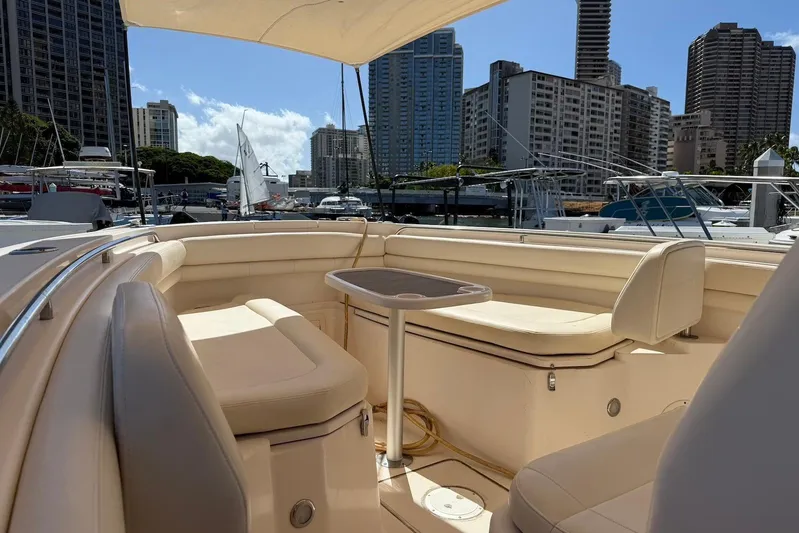  Yacht Photos Pics 2020 Grady-White Canyon 306 boat interior with seating, docked in urban marina.