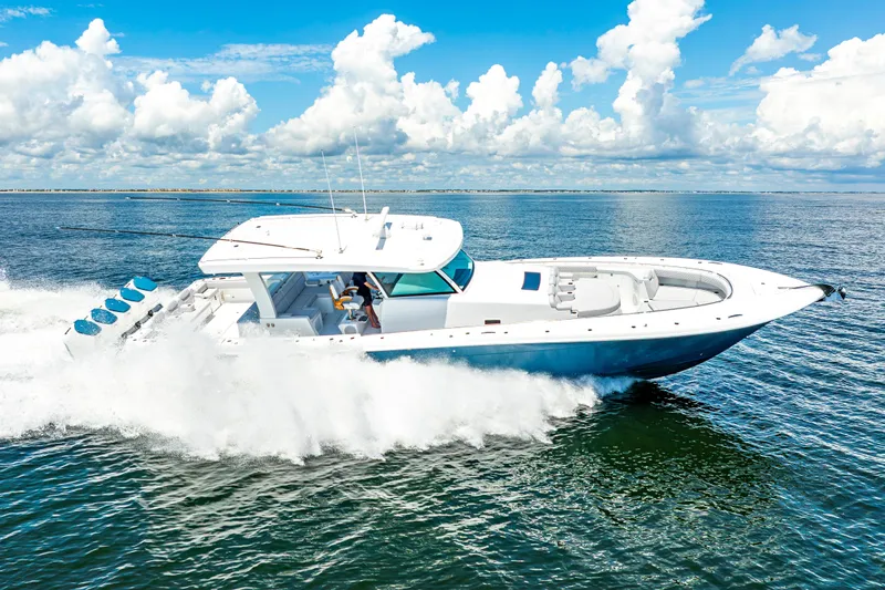  Yacht Photos Pics 2026 HCB 56 Suenos GIX cruising on open water under a clear blue sky.