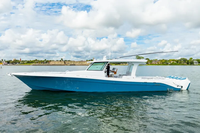  Yacht Photos Pics 2026 HCB 56 Suenos GIX luxury boat on calm water under cloudy sky.