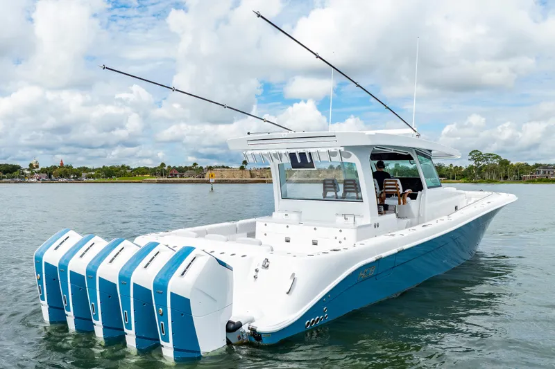  Yacht Photos Pics 2026 HCB 56 Suenos GIX boat with multiple engines on a calm waterway.
