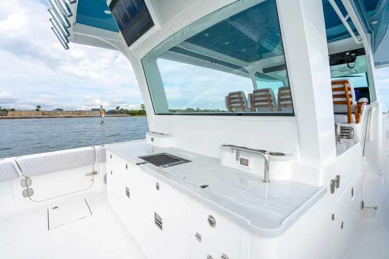  Yacht Photos Pics 2026 HCB 56 Suenos GIX yacht interior with sleek kitchen and seating area.