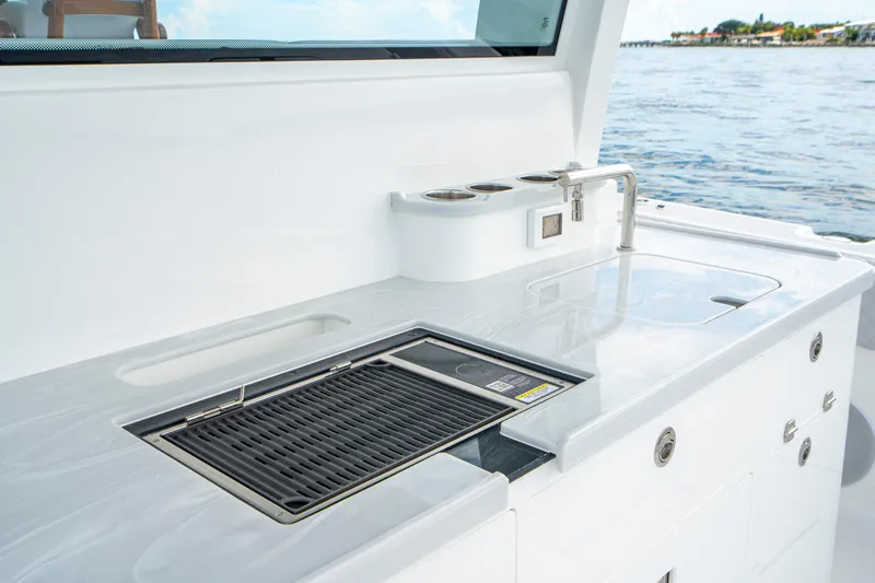  Yacht Photos Pics Outdoor kitchen on 2026 HCB 56 Suenos GIX yacht with grill and sink by the sea.