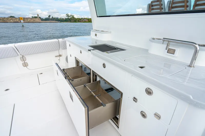  Yacht Photos Pics Luxurious 2026 HCB 56 Suenos GIX yacht kitchen with sleek white cabinetry and modern amenities.
