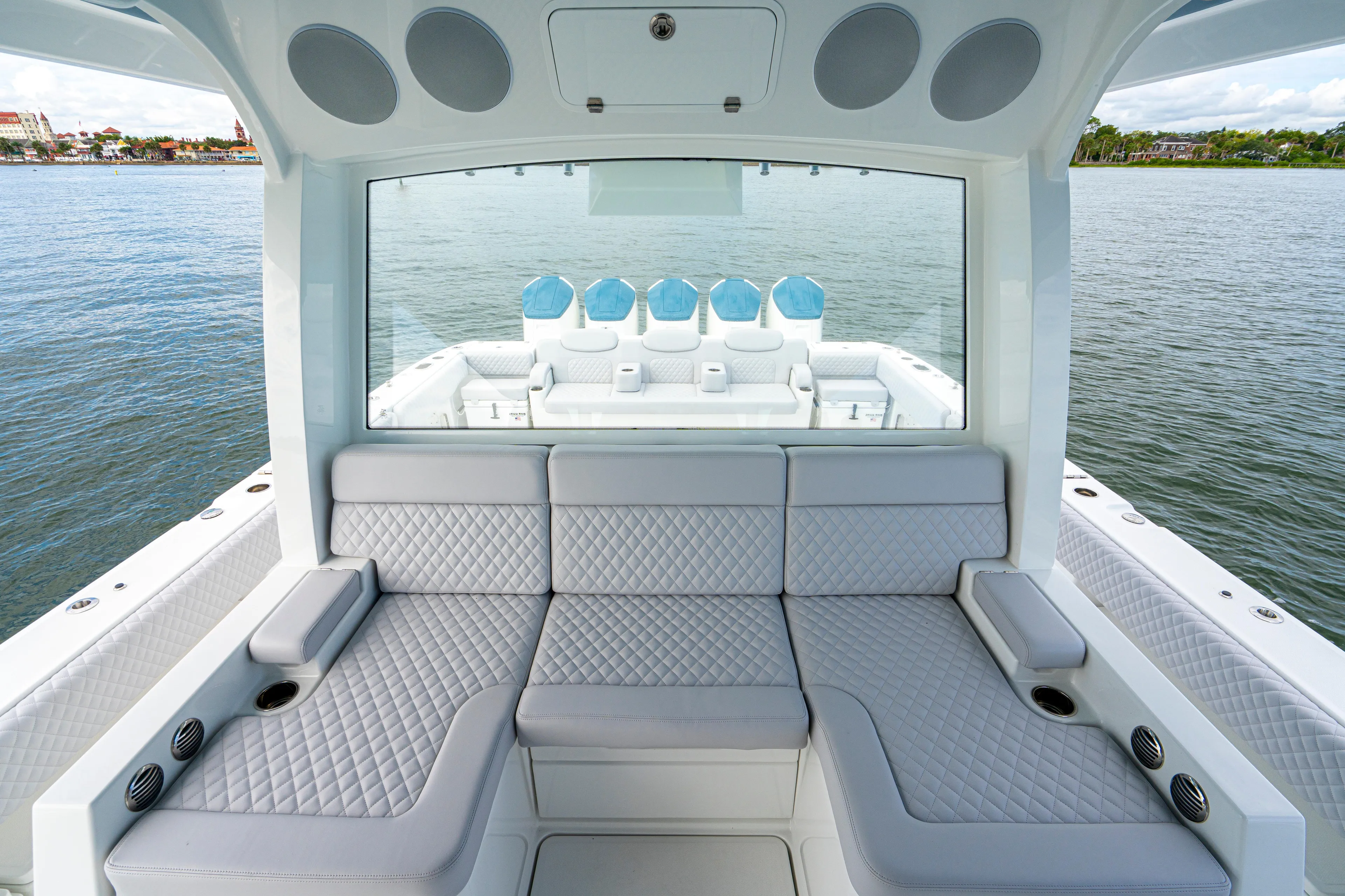  Yacht Photos Pics Luxurious interior of 2026 HCB 56 Suenos GIX yacht with quilted seating and ocean view.