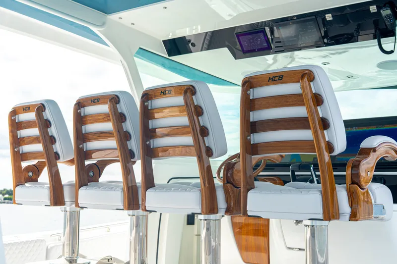  Yacht Photos Pics Luxury seating on 2026 HCB 56 Suenos GIX boat, featuring elegant wooden and white leather design.
