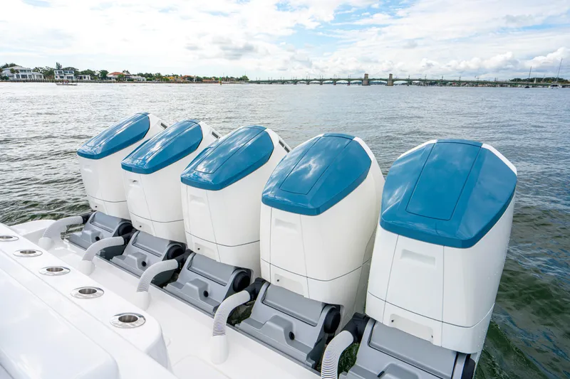  Yacht Photos Pics Four powerful outboard engines on a 2026 HCB 56 Suenos GIX boat, docked by the water.
