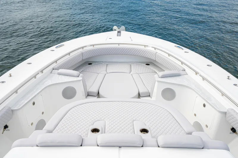  Yacht Photos Pics Luxurious seating area on 2026 HCB 56 Suenos GIX boat, with quilted upholstery and ocean backdrop.