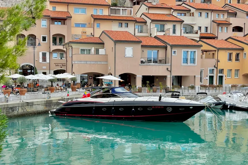  Yacht Photos Pics Sunseeker Predator 58 yacht docked near charming waterfront buildings, 2000 model.