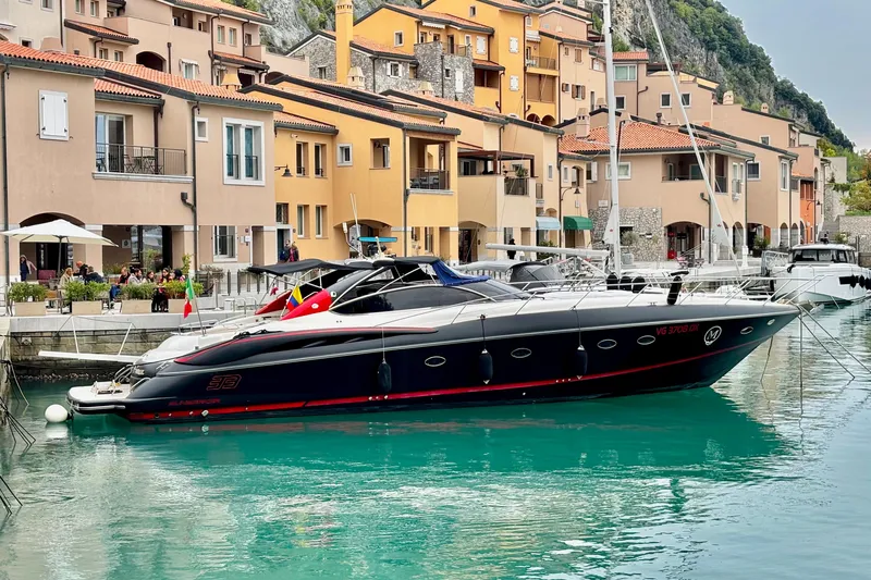  Yacht Photos Pics Sunseeker Predator 58 yacht docked by colorful waterfront buildings, 2000 model.