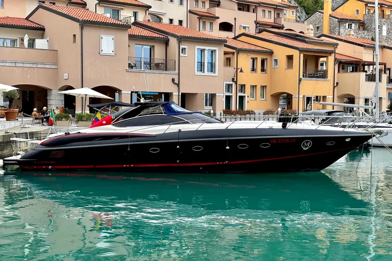  Yacht Photos Pics Luxury Sunseeker Predator 58 yacht docked in a scenic marina, 2000 model.