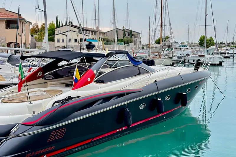  Yacht Photos Pics Sunseeker Predator 58 yacht, 2000 model, docked in a marina with flags displayed.