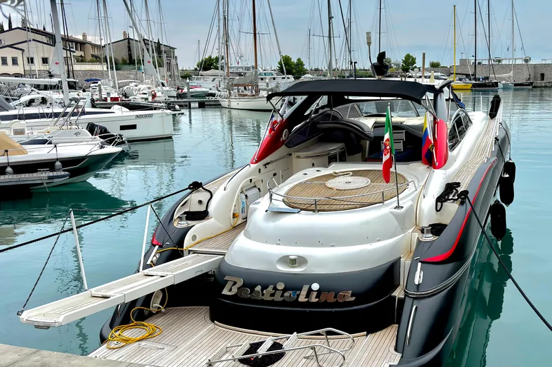  Yacht Photos Pics Sunseeker Predator 58 yacht, 2000 model, docked in a marina with flags displayed.