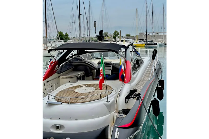  Yacht Photos Pics Sunseeker Predator 58 yacht, 2000 model, docked in a marina with flags displayed.