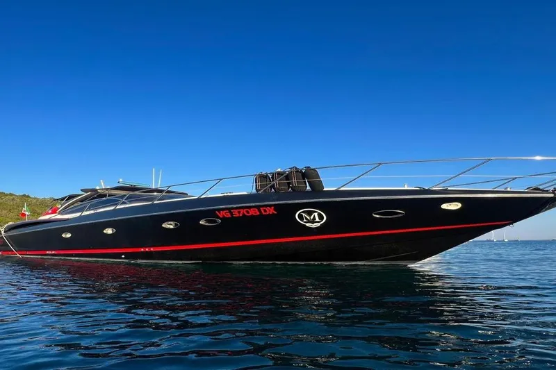  Yacht Photos Pics Sunseeker Predator 58 yacht, 2000 model, sleek black design on calm water.