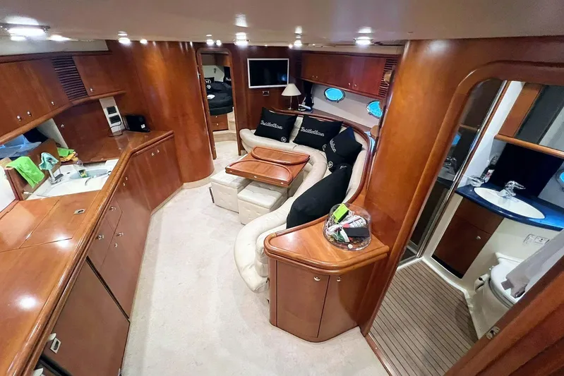  Yacht Photos Pics Luxurious interior of 2000 Sunseeker Predator 58 yacht with elegant wood finishes.