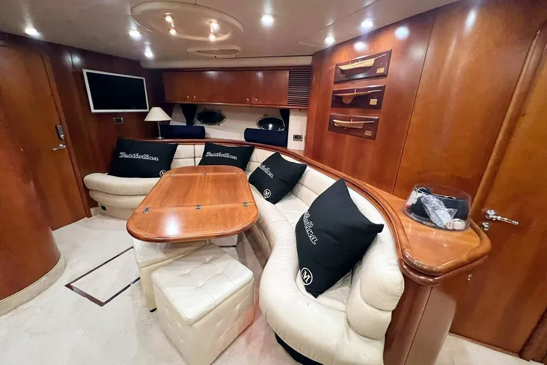  Yacht Photos Pics Luxurious interior of 2000 Sunseeker Predator 58 yacht with elegant wood finish and plush seating.