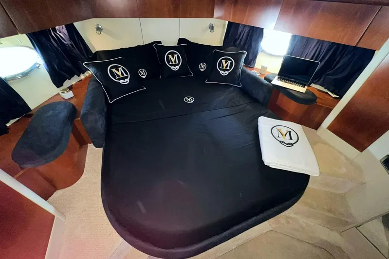  Yacht Photos Pics Luxurious cabin interior of 2000 Sunseeker Predator 58 yacht with elegant bedding and laptop.