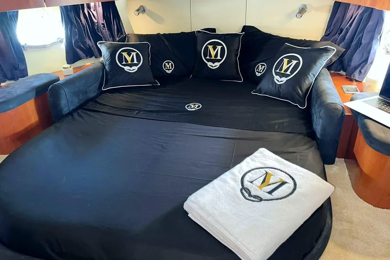  Yacht Photos Pics Luxurious Sunseeker Predator 58 yacht bedroom with black bedding and embroidered pillows, 2000 model.