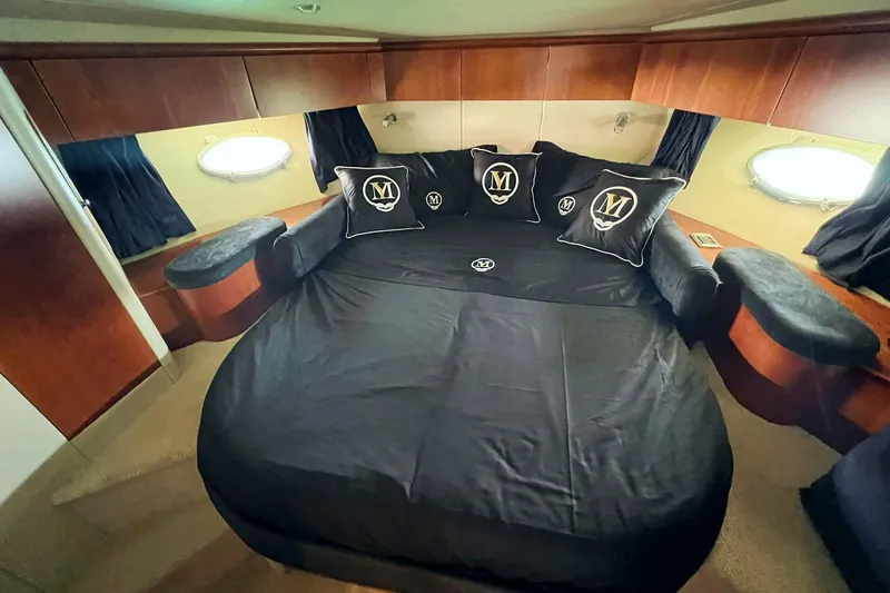  Yacht Photos Pics Luxurious cabin interior of 2000 Sunseeker Predator 58 yacht with elegant bedding.