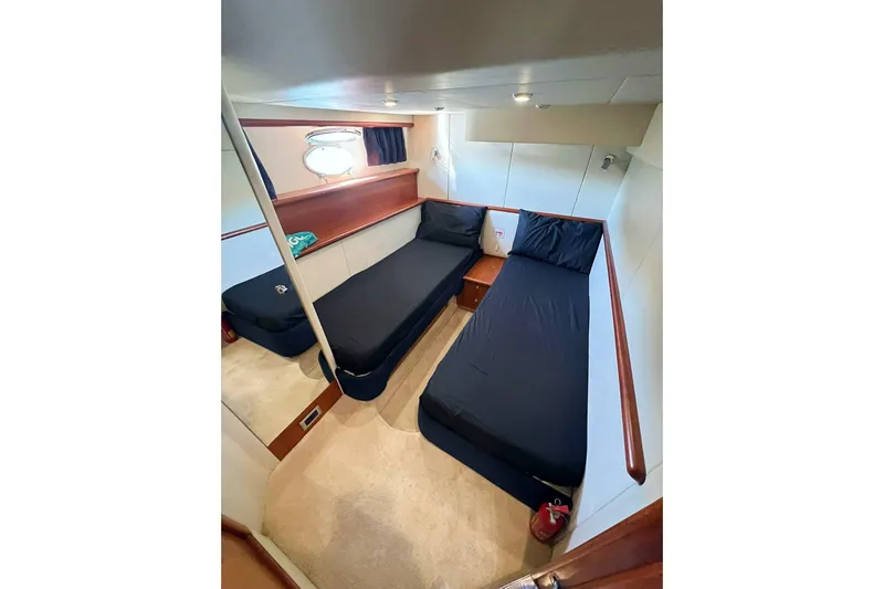  Yacht Photos Pics Interior cabin of 2000 Sunseeker Predator 58 yacht with twin beds and modern decor.