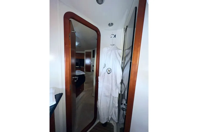  Yacht Photos Pics Interior of 2000 Sunseeker Predator 58 yacht, featuring a cozy cabin and bathrobe.