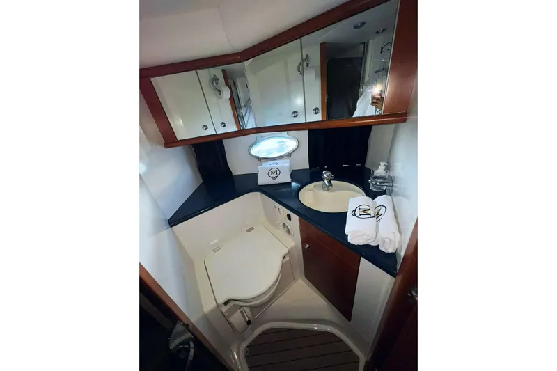  Yacht Photos Pics Luxurious bathroom in 2000 Sunseeker Predator 58 yacht with modern fixtures and elegant design.