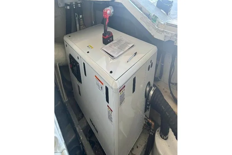  Yacht Photos Pics Engine room of 2000 Sunseeker Predator 58 with generator and tools.