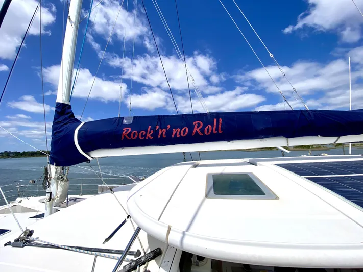 Rock N' No Roll Yacht Photos Pics Sailboat Privilege 435, 2006 model, with "Rock'n'no Roll" sail cover, under blue sky.